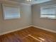 This bedroom boasts hardwood floors, white trim, and two windows for ample natural light at 375 6Th Ne St # 5, Atlanta, GA 30308
