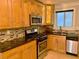 Well-equipped kitchen boasting stainless steel appliances, a stylish backsplash, and wooden cabinets at 375 6Th Ne St # 5, Atlanta, GA 30308