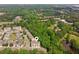 Aerial view of townhomes nestled in lush greenery near a pond, and community amenities at 4173 Chatham Ridge Dr, Buford, GA 30518