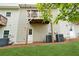 Backyard view shows a home's exterior with a deck, door, and lush green grass at 4173 Chatham Ridge Dr, Buford, GA 30518