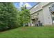 Lush green backyard view, highlighting the home's exterior with a deck and mature trees at 4173 Chatham Ridge Dr, Buford, GA 30518