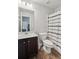 Bathroom featuring a shower with a curtain, a white sink, wood look tile flooring, and updated fixtures at 4173 Chatham Ridge Dr, Buford, GA 30518
