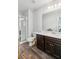 Bathroom with a tiled shower, white countertops, modern lighting, and wood look tile flooring at 4173 Chatham Ridge Dr, Buford, GA 30518