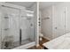 Beautiful bathroom features a tiled shower, white cabinets, wood look tile flooring, and modern fixtures at 4173 Chatham Ridge Dr, Buford, GA 30518