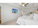 Bright primary bedroom features a tray ceiling, ceiling fan, and neutral decor at 4173 Chatham Ridge Dr, Buford, GA 30518