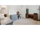 Bright bedroom with a desk, shelves, and lots of room for a bed and other furniture at 4173 Chatham Ridge Dr, Buford, GA 30518