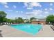 Community pool surrounded by lounge chairs and a clubhouse, perfect for relaxation and recreation at 4173 Chatham Ridge Dr, Buford, GA 30518
