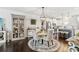 Bright dining area featuring an elegant light fixture and dark wood floors, adjacent to the spacious kitchen at 4173 Chatham Ridge Dr, Buford, GA 30518