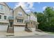Inviting townhomes feature brick accents, individual garages, and manicured landscaping at 4173 Chatham Ridge Dr, Buford, GA 30518