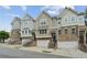 Beautiful townhomes featuring brick accents, individual garages, and welcoming front entrances at 4173 Chatham Ridge Dr, Buford, GA 30518