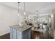 Well-equipped kitchen featuring white cabinets, stainless steel appliances, granite counters, and a center island with bar stool seating at 4173 Chatham Ridge Dr, Buford, GA 30518