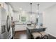 Well-equipped kitchen featuring white cabinets, stainless steel appliances, granite counters, and a center island with bar stool seating at 4173 Chatham Ridge Dr, Buford, GA 30518