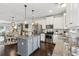 Well-equipped kitchen featuring white cabinets, stainless steel appliances, granite counters, and a center island with bar stool seating at 4173 Chatham Ridge Dr, Buford, GA 30518