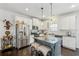 Well-equipped kitchen featuring white cabinets, stainless steel appliances, granite counters, and a center island with bar stool seating at 4173 Chatham Ridge Dr, Buford, GA 30518