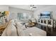 Comfortable living room with a large sectional sofa, hardwood floors, and lots of natural light from the large window at 4173 Chatham Ridge Dr, Buford, GA 30518