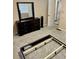 View of empty bedroom with neutral walls, dresser, and a partial view of a bed frame at 6540 Old White Mill Road Rd, Fairburn, GA 30213