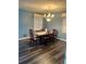 Cozy dining room with a chandelier, wood table with chairs and a window providing natural light at 6540 Old White Mill Road Rd, Fairburn, GA 30213