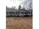 Charming ranch-style home featuring gray siding, black shutters, and a well-manicured front yard at 6540 Old White Mill Road Rd, Fairburn, GA 30213