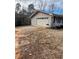 Spacious two-car garage with white doors, ample parking space, and well-maintained exterior features at 6540 Old White Mill Road Rd, Fairburn, GA 30213