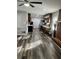 Open-concept kitchen with stainless steel appliances, dark wood cabinets, and luxury vinyl plank flooring at 6540 Old White Mill Road Rd, Fairburn, GA 30213