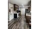 View of kitchen featuring dark wood cabinets, white appliances, and modern gray-toned flooring at 6540 Old White Mill Road Rd, Fairburn, GA 30213