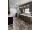 Well-appointed kitchen featuring dark wood cabinets, stainless steel appliances, and easy-to-clean, waterproof floors at 6540 Old White Mill Road Rd, Fairburn, GA 30213