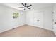 Bright bedroom boasts a ceiling fan, spacious closet, and lots of natural light at 2105 Royal Fox Way, Decatur, GA 30032