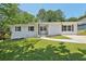 Charming exterior of home with manicured lawn, featuring a brick facade, dark shutters, and a concrete walkway at 2105 Royal Fox Way, Decatur, GA 30032
