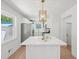 Kitchen featuring white cabinets, quartz countertops, stainless steel appliances and a gold pendant light over the center island at 2105 Royal Fox Way, Decatur, GA 30032