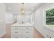Bright and open kitchen featuring an island with seating, white cabinets and stainless steel appliances at 2105 Royal Fox Way, Decatur, GA 30032