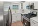 Bright kitchen featuring stainless steel appliances, white cabinetry, and hardwood floors at 2105 Royal Fox Way, Decatur, GA 30032