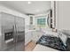 Bright kitchen featuring stainless steel appliances, white cabinetry, and stone countertops at 2105 Royal Fox Way, Decatur, GA 30032
