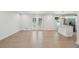 Open floor plan featuring a living room with wood floors flowing into a modern white kitchen with stainless steel appliances at 2105 Royal Fox Way, Decatur, GA 30032