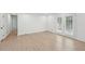 Living room featuring wood flooring, white walls, glass patio doors, and a view into the kitchen at 2105 Royal Fox Way, Decatur, GA 30032