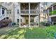 Backyard with covered patio, grill, and lush greenery at 238 Trecastle Sq, Canton, GA 30114