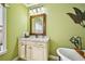 Bathroom vanity with granite countertop and framed mirror with stylish lighting fixture above at 238 Trecastle Sq, Canton, GA 30114