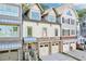 Charming townhome with stone accents, two-car garage, and a welcoming entrance at 238 Trecastle Sq, Canton, GA 30114