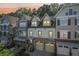 Charming townhome exteriors with unique architectural details and attached garages at 238 Trecastle Sq, Canton, GA 30114