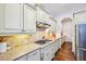 Stylish kitchen equipped with a gas cooktop, tiled backsplash, and ample counter space at 238 Trecastle Sq, Canton, GA 30114