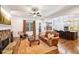 Cozy living room with a stone fireplace, hardwood floors, and a view into the kitchen at 238 Trecastle Sq, Canton, GA 30114