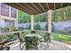 Patio featuring a table and chairs overlooking lush landscaping and privacy wall at 238 Trecastle Sq, Canton, GA 30114