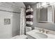 Bathroom featuring shower over tub with subway tile, mosaic accent and a marble vanity at 4251 Lantern Hill Dr, Dacula, GA 30019