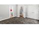 Bedroom featuring carpet, white trim and a view into the bathroom with a double door closet at 4251 Lantern Hill Dr, Dacula, GA 30019