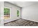This bedroom has two windows providing plenty of natural light and gray carpet at 4251 Lantern Hill Dr, Dacula, GA 30019
