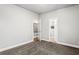 Carpeted bedroom featuring a window and doorways to another room and bathroom at 4251 Lantern Hill Dr, Dacula, GA 30019