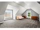 The bonus room includes carpet, dormer windows, and seating at 4251 Lantern Hill Dr, Dacula, GA 30019