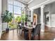 Elegant dining room with large windows, hardwood floors, and stylish chandelier at 4251 Lantern Hill Dr, Dacula, GA 30019