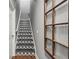 Hallway with decorative stair design and rustic window frame wall decoration at 4251 Lantern Hill Dr, Dacula, GA 30019