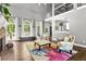Bright living room with large windows, comfortable seating, and a fireplace at 4251 Lantern Hill Dr, Dacula, GA 30019