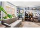 Cozy living room with large window, comfortable seating, and abundant houseplants at 4251 Lantern Hill Dr, Dacula, GA 30019
